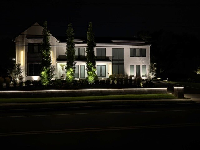 Architectural lighting across the front elevation of a Newton, MA home.