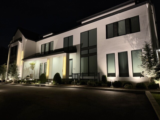 Front yard and house uplighting on a residential property in Newton, MA.