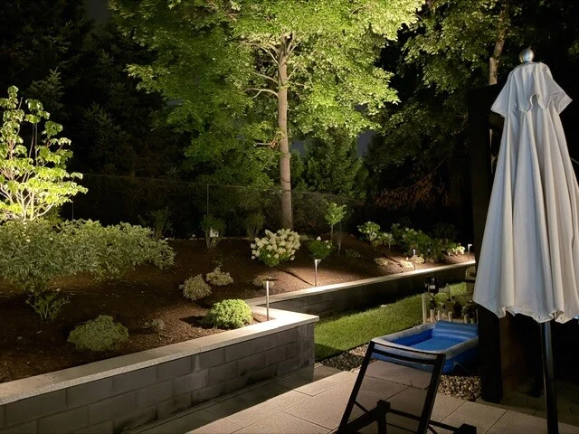 Garden step and retaining wall lighting on a landscaped patio in Newton, MA.