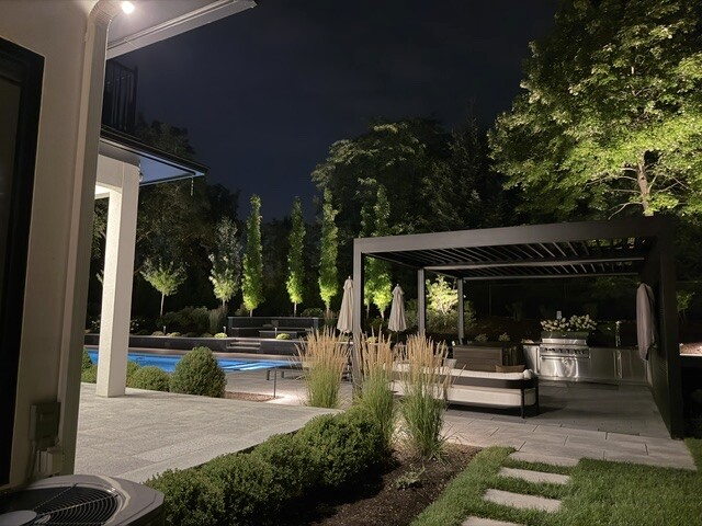Outdoor lighting around a residential patio and pergola in Newton, MA.